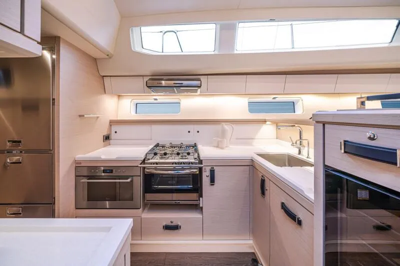 Slide: The Image of Manufacturer Provided Image: Modern kitchen interior of 2026 Jeanneau 65 yacht, featuring sleek appliances and ample counter space. - 11