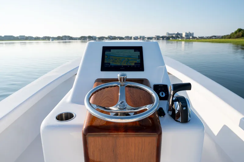 Slide: The Image of 2021 Harrison Boatworks 23 Center Console steering view on calm water. - 15