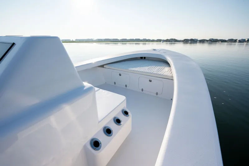 Slide: The Image of 2021 Harrison Boatworks 23 Center Console on calm water, showcasing sleek design and spacious deck. - 25