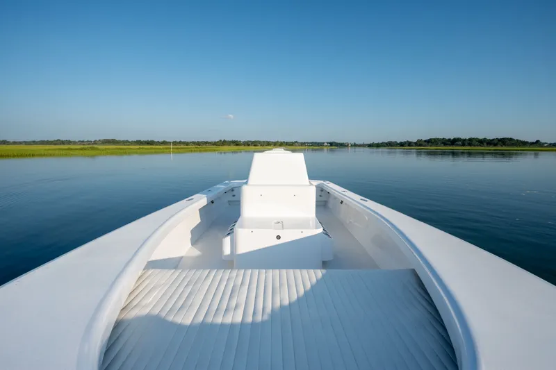 Slide: The Image of 2021 Harrison Boatworks 23 Center Console on calm water, clear sky background. - 29