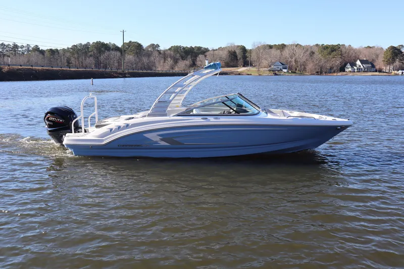 The Image of 2025 Chaparral 23 SSi OB boat cruising on a serene lake. - 1