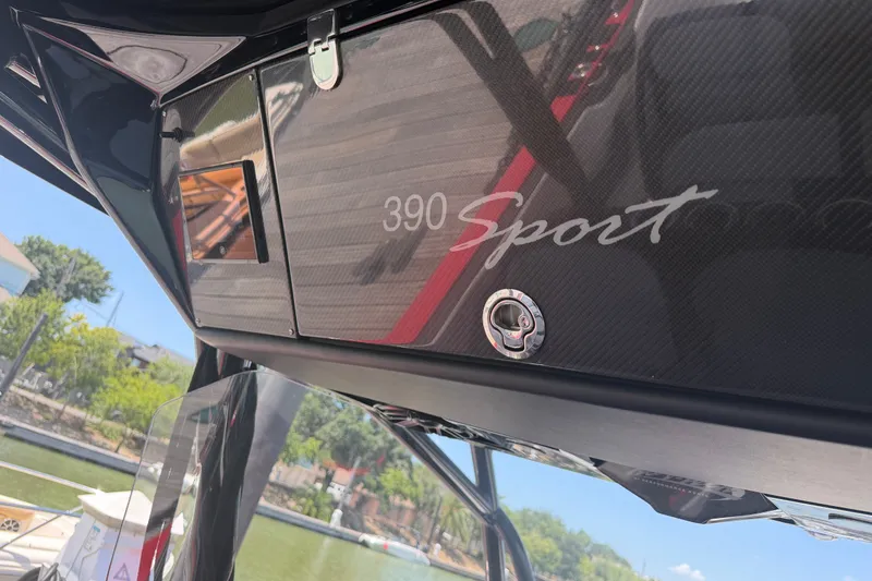 Slide: The Image of 2024 Nor-Tech 390 Sport boat dashboard with sleek carbon fiber finish. - 36