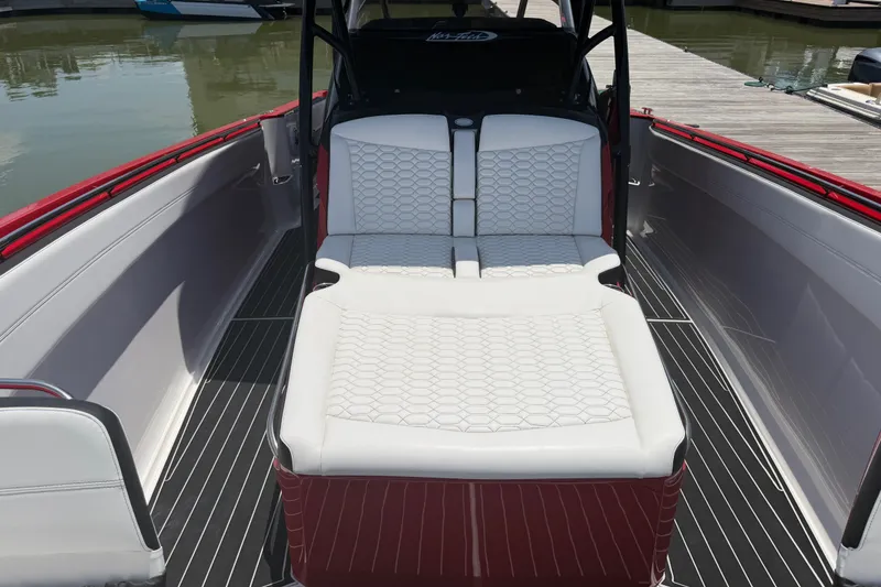 Slide: The Image of 2024 Nor-Tech 390 Sport boat interior with white cushioned seating and sleek design. - 24