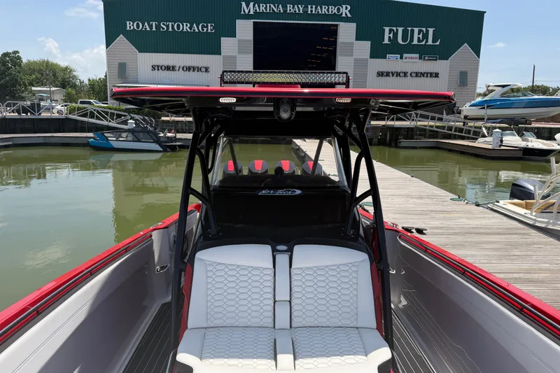 Slide: The Image of 2024 Nor-Tech 390 Sport boat docked at Marina Bay Harbor with storage and fuel services. - 23