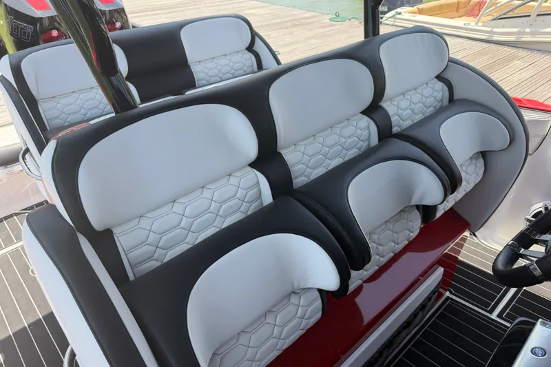 Slide: The Image of 2024 Nor-Tech 390 Sport boat interior with luxurious white and black seating. - 39