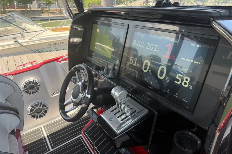 Slide: The Image of 2024 Nor-Tech 390 Sport boat dashboard with advanced digital controls and steering wheel. - 40
