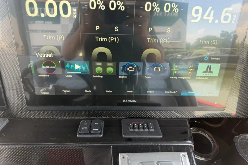 Slide: The Image of Dashboard of 2024 Nor-Tech 390 Sport boat with Garmin display and controls. - 33