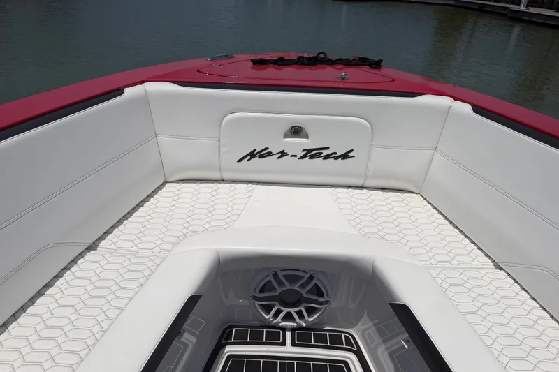 Slide: The Image of 2024 Nor-Tech 390 Sport boat interior with white seating and hexagonal flooring. - 25