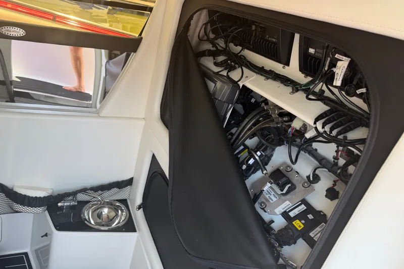 Slide: The Image of Interior view of 2024 Nor-Tech 390 Sport boat's wiring and sink area. - 28