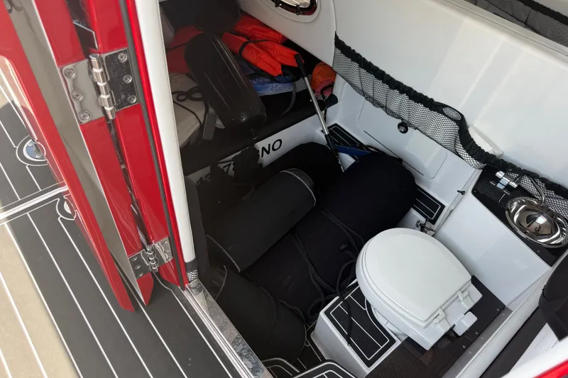 Slide: The Image of Interior of 2024 Nor-Tech 390 Sport boat with storage and compact toilet. - 29