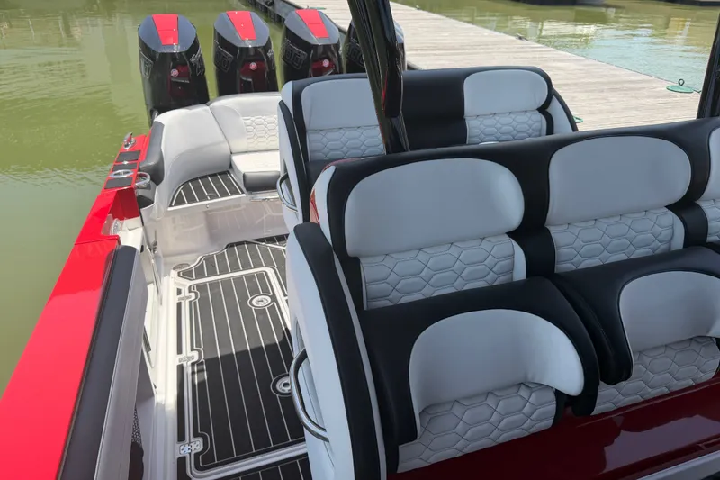 Slide: The Image of 2024 Nor-Tech 390 Sport boat interior with stylish seating and powerful engines. - 38