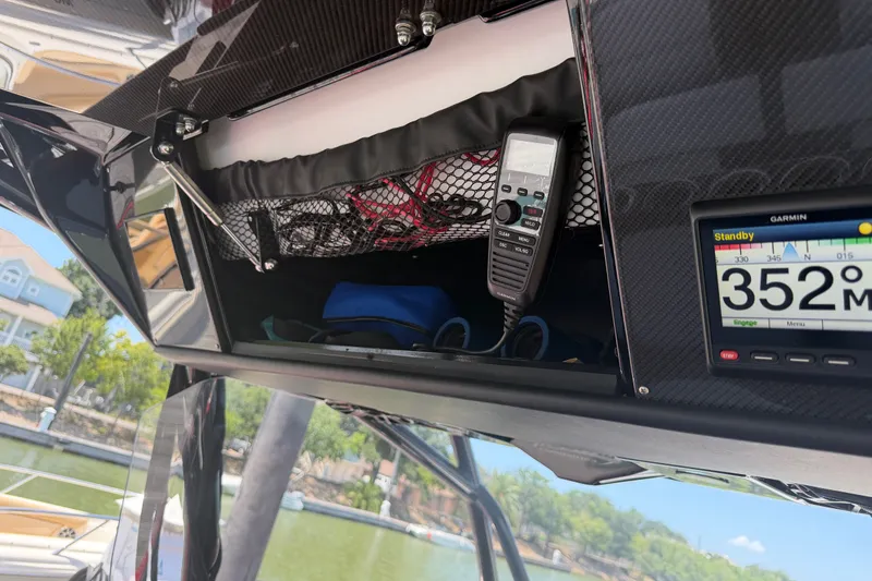 Slide: The Image of 2024 Nor-Tech 390 Sport boat dashboard with Garmin display and communication equipment. - 37