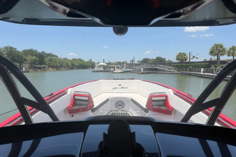 Slide: The Image of 2024 Nor-Tech 390 Sport boat on a serene waterway, showcasing sleek design and vibrant red accents. - 31