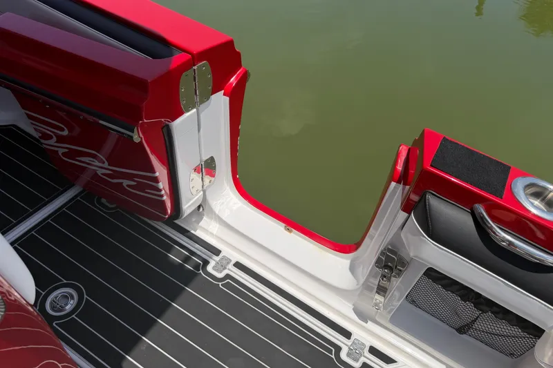 Slide: The Image of 2024 Nor-Tech 390 Sport boat with red and black interior, open side door, and water view. - 19