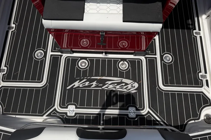 Slide: The Image of 2024 Nor-Tech 390 Sport boat deck with logo and seating, featuring sleek black and white design. - 43