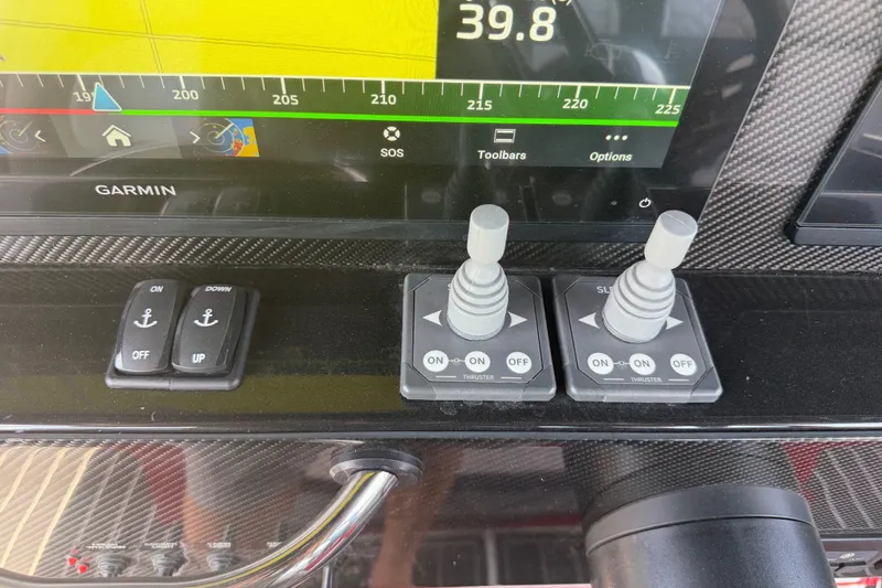Slide: The Image of Control panel of 2024 Nor-Tech 390 Sport boat with Garmin display and thruster controls. - 18