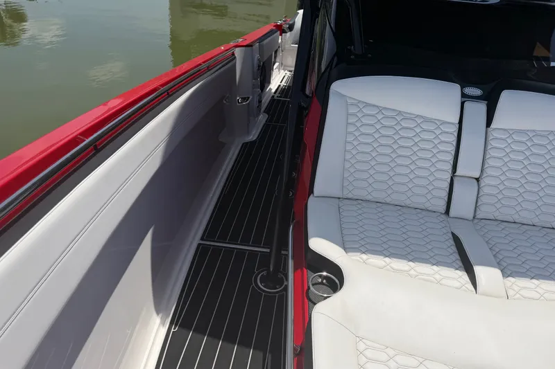Slide: The Image of 2024 Nor-Tech 390 Sport boat interior with white hexagonal-patterned seats and red accents. - 22
