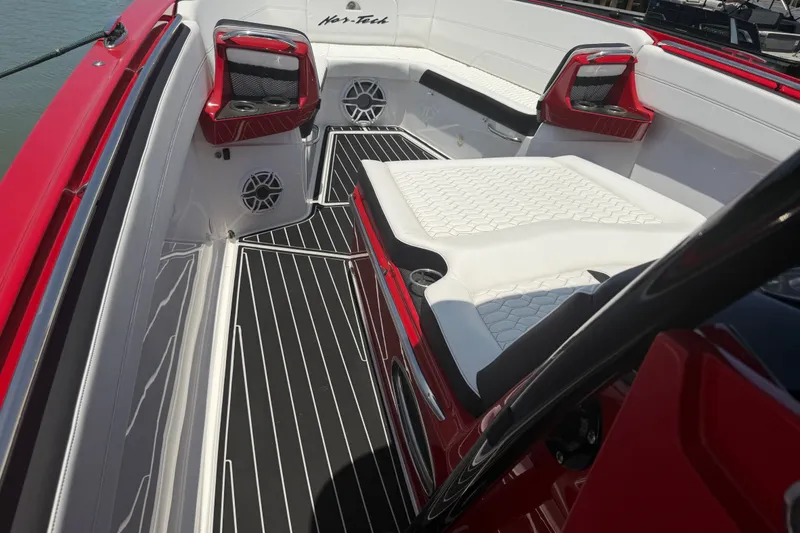 Slide: The Image of 2024 Nor-Tech 390 Sport boat interior with red accents and white seating. - 27