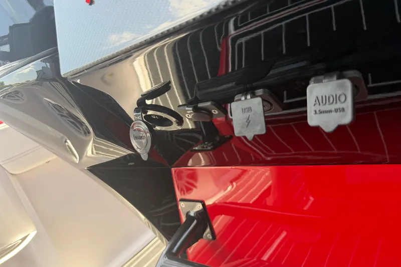 Slide: The Image of 2024 Nor-Tech 390 Sport boat with USB and audio ports on the dashboard. - 15