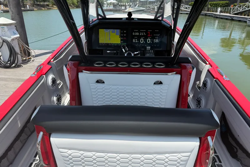 Slide: The Image of 2024 Nor-Tech 390 Sport boat interior with modern dashboard and luxurious seating. - 46