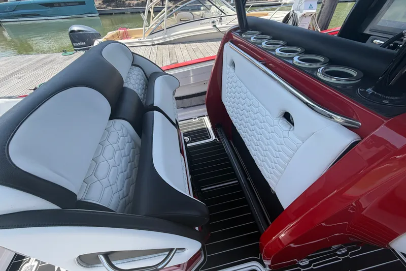 Slide: The Image of Luxurious seating on 2024 Nor-Tech 390 Sport boat with stylish red and white interior. - 42