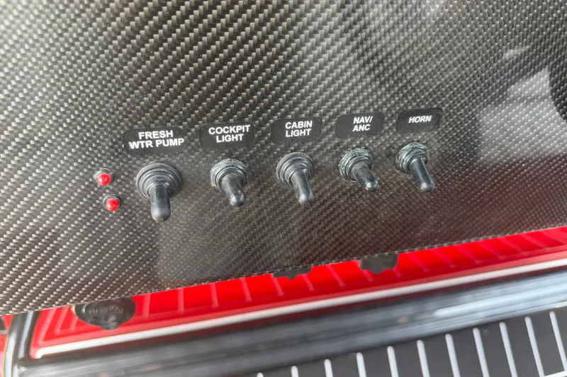 Slide: The Image of Control panel of 2024 Nor-Tech 390 Sport boat with labeled switches. - 14