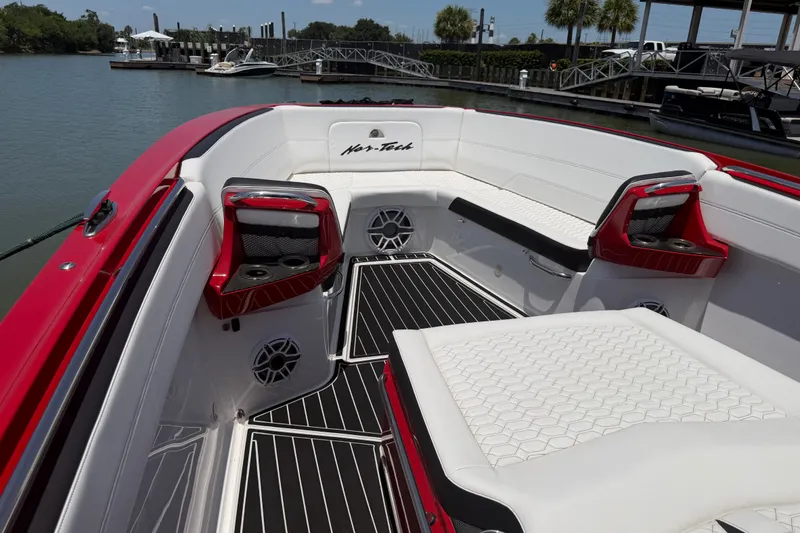 Slide: The Image of 2024 Nor-Tech 390 Sport boat interior with red accents and white seating. - 26