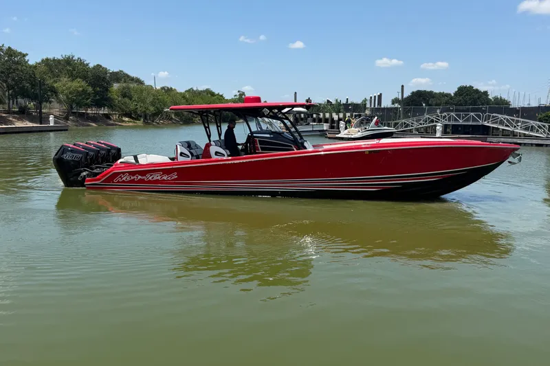 The Image of 2024 Nor-Tech 390 Sport boat in vibrant red on calm water. - 1