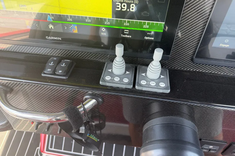 Slide: The Image of Dashboard of 2024 Nor-Tech 390 Sport boat with Garmin display and controls. - 35