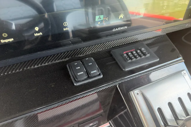 Slide: The Image of Dashboard of 2024 Nor-Tech 390 Sport with Garmin display and Mercury controls. - 17