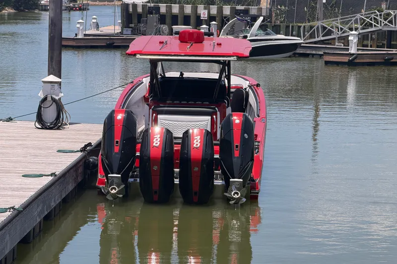 Slide: The Image of 2024 Nor-Tech 390 Sport boat with triple 400R engines docked in a marina. - 49