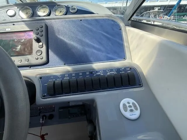 Slide: The Image of The image shows the dashboard of a 2004 Bayliner 305SB with instruments and switches. - 15