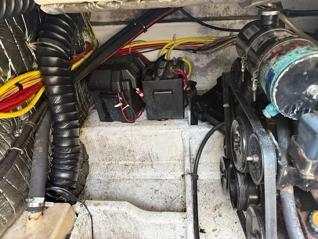 Slide: The Image of The engine compartment of a 2004 Bayliner 305SB shows cables, batteries, and engine components. - 22