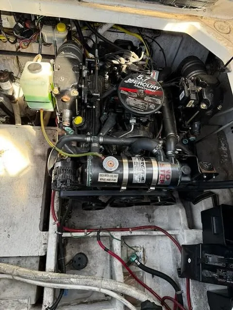 Slide: The Image of The engine compartment of a 2004 Bayliner 305SB shows a Mercury engine with various hoses and cables. - 17