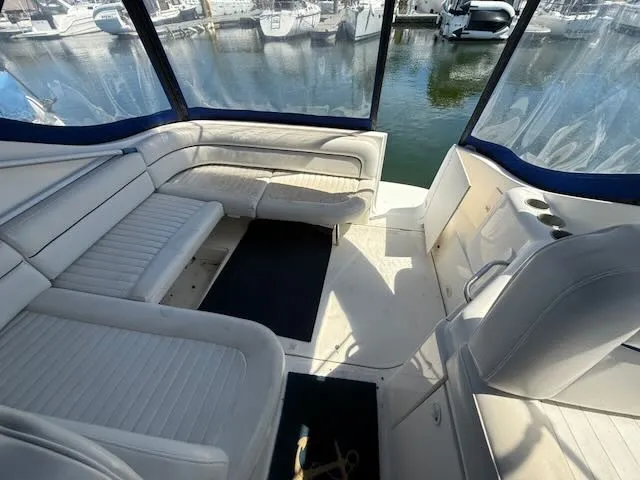 Slide: The Image of The image shows the cockpit of a 2004 Bayliner 305SB with white cushioned seating and a marina in the background. - 9