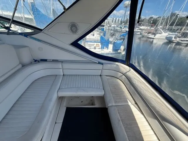 Slide: The Image of The image shows the cockpit of a 2004 Bayliner 305SB with white cushioned seating and blue accents. - 7