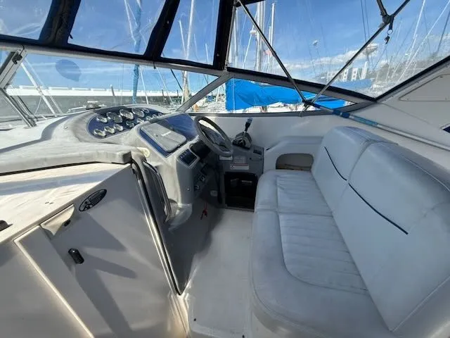 Slide: The Image of The image shows the cockpit of a 2004 Bayliner 305SB with white seating and a helm station. - 11