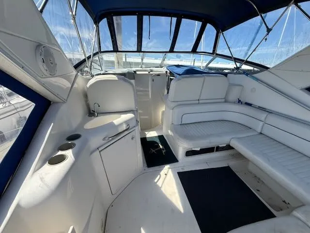Slide: The Image of The image shows the cockpit of a 2004 Bayliner 305SB with white seating and blue accents. - 3