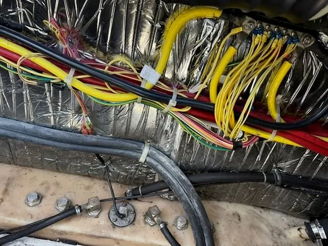 Slide: The Image of A view of the wiring and insulation in the engine compartment of a 2004 Bayliner 305SB. - 21