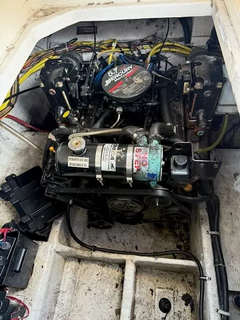 Slide: The Image of The engine compartment of a 2004 Bayliner 305SB features a 5.7-liter Mercury engine with wiring. - 19