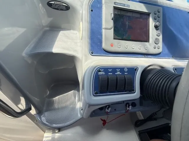 Slide: The Image of The image shows the dashboard of a 2004 Bayliner 305SB with a navigation system. - 16