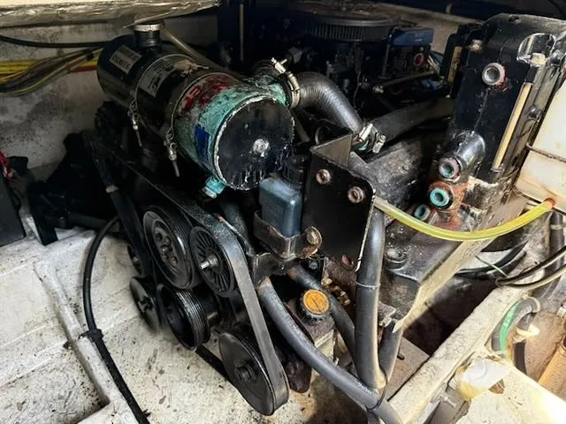 Slide: The Image of The engine compartment of a 2004 Bayliner 305SB shows a complex engine with multiple belts and hoses. - 20