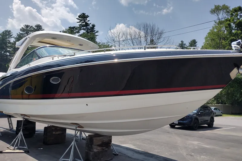 Slide: The Image of 2026 Formula 350 Crossover Bowrider on stands, sleek design, under clear sky. - 8