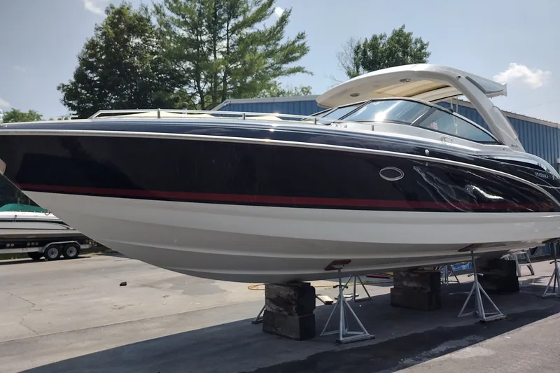 Slide: The Image of 2026 Formula 350 Crossover Bowrider boat on stands, outdoors, under clear sky. - 3