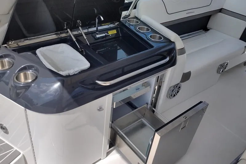 Slide: The Image of 2026 Formula 350 Crossover Bowrider interior with kitchenette and seating area. - 29
