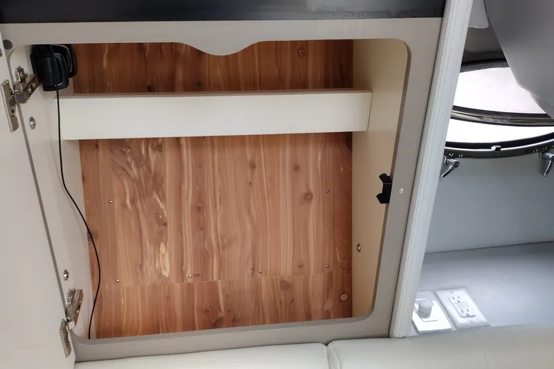 Slide: The Image of Interior storage compartment of 2026 Formula 350 Crossover Bowrider with wood finish. - 47