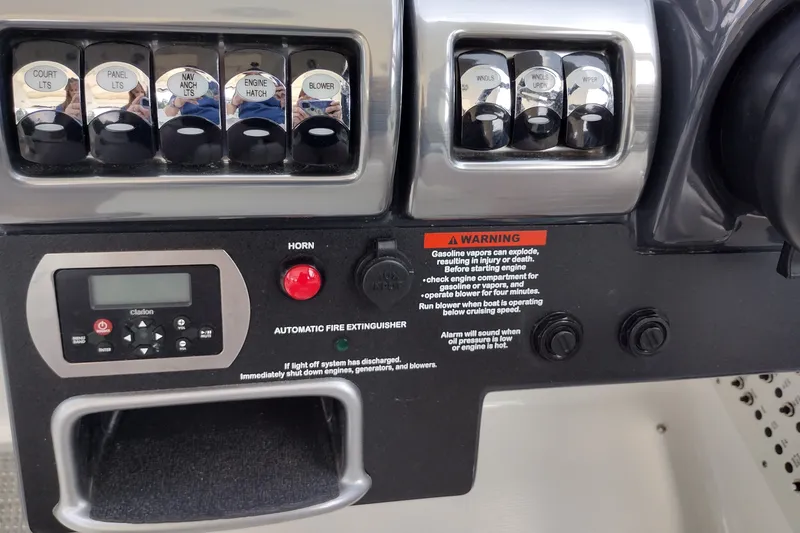 Slide: The Image of Control panel of 2026 Formula 350 Crossover Bowrider with switches and warning label. - 32