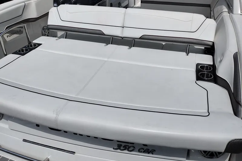 Slide: The Image of 2026 Formula 350 Crossover Bowrider boat interior with white seating and cup holders. - 62