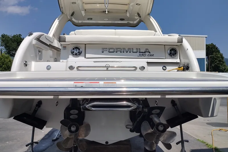 Slide: The Image of 2026 Formula 350 Crossover Bowrider boat rear view with dual propellers and sleek design. - 14