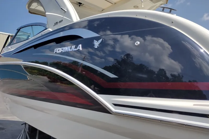 Slide: The Image of 2026 Formula 350 Crossover Bowrider boat with sleek design and reflective finish. - 11